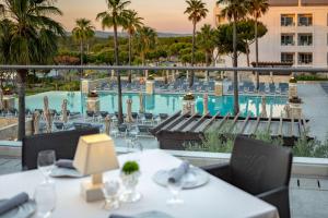 a restaurant with a view of a swimming pool at Conrad Algarve in Quinta do Lago