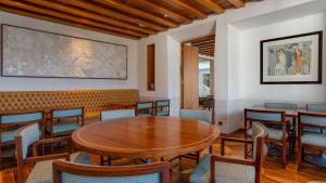 a dining room with a wooden table and chairs at Conrad Algarve in Quinta do Lago