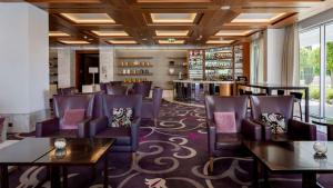a dining room with purple chairs and tables at Conrad Algarve in Quinta do Lago