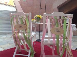 two white chairs with ribbons sitting next to each other at Hilton Vilamoura in Vilamoura