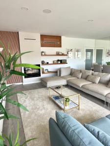 a living room with a couch and a table at Douro Escape - Riverfront Apartment in Peso da Régua