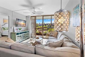 a living room with a couch and a table at Kahana Manor 619 in Kahana