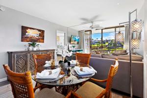 a living room with a table and chairs and a couch at Kahana Manor 619 in Kahana +29 photos