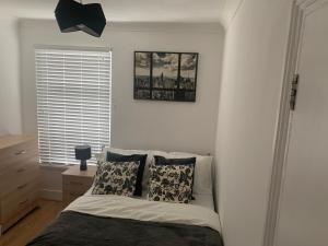 a bedroom with a bed and a window at Central Stratford Cozy Double Room in London