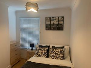 a bedroom with a bed and a window at Central Stratford Cozy Double Room in London