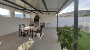 a patio with a table and chairs in a house at Casa en zona rural a 200 m de Ariño (Teruel) in Ariño