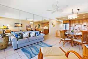 a living room with a couch and a dining room at Kahana Reef 408 in Kahana