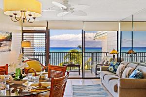 a living room with a couch and a table at Kahana Reef 408 in Kahana +15 photos