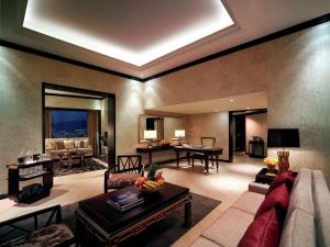 a living room with a couch and a table at Conrad Hong Kong in Hong Kong