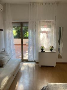 a bedroom with a bed and a table with two potted plants at Terrace! in Rome