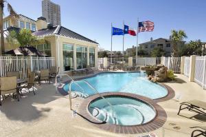 a swimming pool with two flags on a patio at Hilton Garden Inn Houston/Galleria Area in Houston