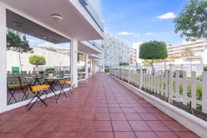 a patio with chairs and tables on a building at Holiday Home Luxury Loft GC in Maspalomas