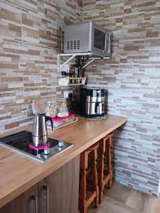 a kitchen with a counter with a stove and a microwave at Casa Azul Mountain Retreat in Las Lagunetas