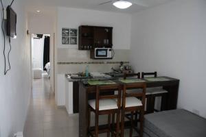 a kitchen with a counter and stools in a room at Hanna Apart in Federación