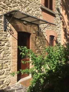 a brick building with a door and a window at B&B Terra & Sole in Novafeltria