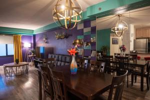 a dining room with a table with flowers in a vase at StayTogetherSuites 760 in Las Vegas