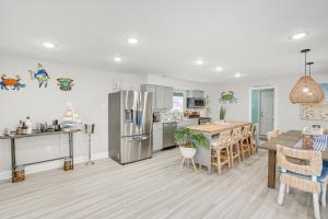 a kitchen and dining room with a refrigerator and a table at Wildwood Home with Deck - Walk to Beach and Boardwalk! in Wildwood