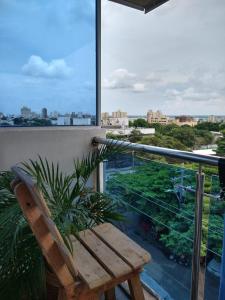 una panca di legno seduta in cima a un balcone di The Mendoza Grand Hotel a Barranquilla