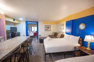 a hotel room with a bed and a bar at Stay Together Suites on The Strip - 1 Bedroom Suite 1012 in Las Vegas