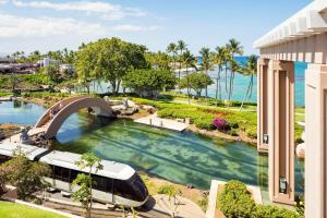 a train in a pool next to the ocean at Hilton Waikoloa Village in Waikoloa