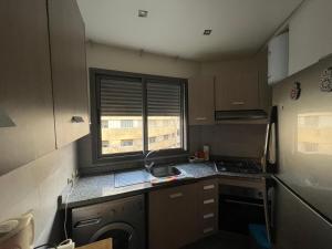 a small kitchen with a sink and a window at Bel appart+2 ROOM+WIFI+GARE CASA VOYAGEUR+TRAM in Casablanca