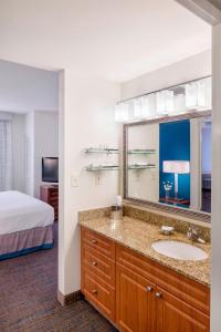 a bathroom with a sink and a large mirror at Residence Inn Portland Downtown/RiverPlace in Portland