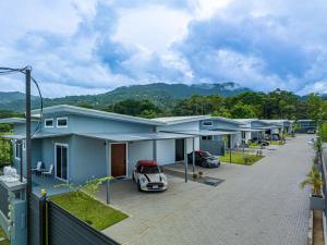 a row of houses with cars parked in a parking lot at Casamar Villa's in Uvita