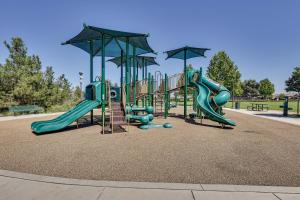 a playground in a park with slides and swings at Large Menifee Home 1 Block to Neighborhood Park! in Menifee
