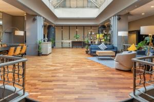 a lobby of a hotel with couches and chairs at Hilton London Kensington Hotel in London