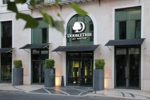 a building with a sign on the front of it at DoubleTree by Hilton Lisbon Fontana Park in Lisbon