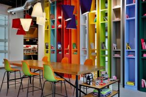 a room with a table and chairs and colorful walls at Aloft Al Mina, Dubai Jumeirah in Dubai