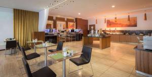 a restaurant with tables and chairs and a counter at Hilton Liverpool City Centre in Liverpool