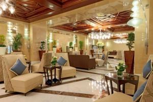 a lobby of a hotel with chairs and tables at Hilton Suites Jabal Omar Makkah in Mecca