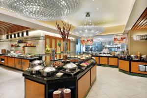 a buffet line in a restaurant with many food at Hilton Suites Jabal Omar Makkah in Mecca