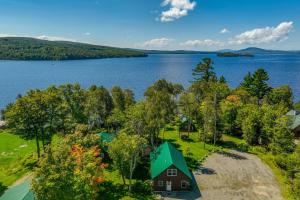 an aerial view of a house on the shore of a lake at Maine Cabin Rental on Rangeley Lake! in Rangeley