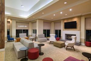 a lobby with a couch and chairs and a fireplace at Hilton Garden Inn Hershey in Hummelstown