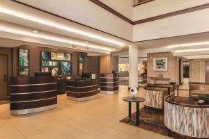 a lobby of a hotel with a waiting area at Embassy Suites by Hilton Orlando International Drive ICON Park in Orlando