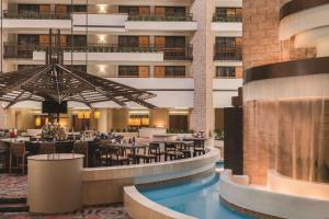 a rendering of the lobby of a hotel with a restaurant at Embassy Suites by Hilton Orlando International Drive ICON Park in Orlando