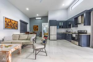 a living room with a couch and a table at Casamar Villa's in Uvita