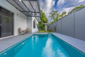 a swimming pool in the backyard of a house at Casamar Villa's in Uvita