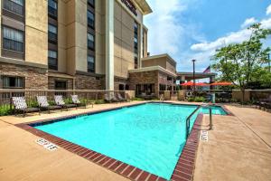 a swimming pool in front of a hotel at Hampton Inn & Suites Memphis-Wolfchase Galleria in Memphis