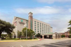 a hotel with a clock tower on top of a building at Embassy Suites Montgomery - Hotel & Conference Center in Montgomery