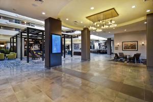 a lobby of a building with a television in it at Embassy Suites Montgomery - Hotel & Conference Center in Montgomery