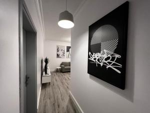 a living room with a picture on the wall at Artistic Apartment in Riyadh in Riyadh