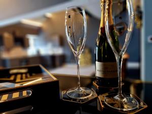 a bottle of champagne and two glasses on a table at The Hamilton - The Studio luxury holiday let's in Scorton