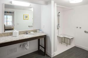 a white bathroom with a sink and a mirror at Hampton Inn & Suites Miami-Doral Dolphin Mall in Miami +27 photos