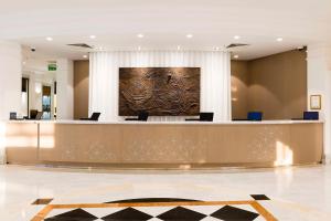 a large lobby with a reception desk in a building at Hilton Malta in St Julian's