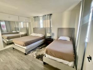 two beds in a room with two beds sidx sidx sidx sidx at Glendora Pool Home Retreat in Glendora