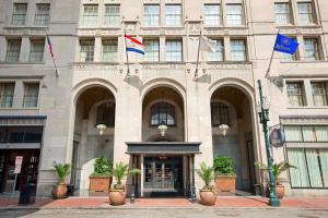 a building with two flags in front of it at Hilton New Orleans / St. Charles Avenue in New Orleans