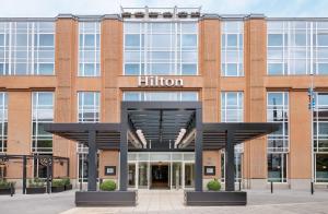 an exterior view of a brick building with a hilton sign at Hilton Munich City in Munich